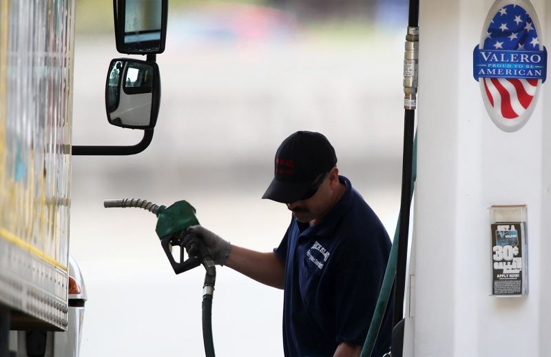 A customer prepares to pump gas into his truck at a Valero gas station in Mill Valley.