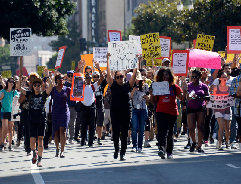 Demonstrators march in downtown Los Angeles protesting the police shooting death of Ezell Ford in August, 2014.