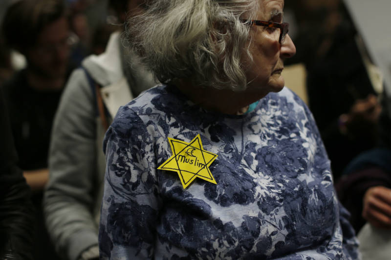 SAN FRANCISCO, CA - JANUARY 28: A woman wears a pin during a rally against muslim immigration ban at San Francisco International Airport on January 28, 2017 in San Francisco, California. President Donald Trump signed an executive order Friday that suspends entry of all refugees for 120 days, indefinitely suspends the entries of all Syrian refugees, as well as barring entries from seven predominantly Muslim countries from entering for 90 days. (Photo by Stephen Lam/Getty Images)