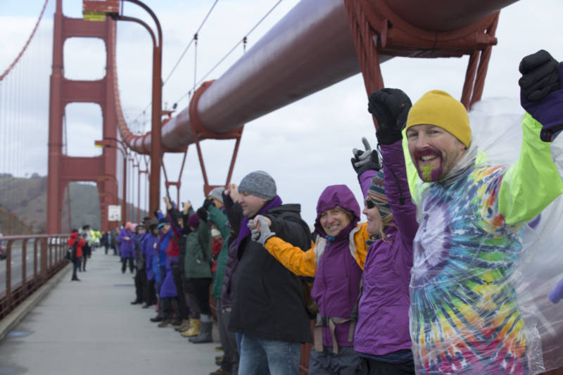 Protestors gathered across the Golden Gate Bridge at about 10 a.m. on Jan. 20, 2017. The participants linked hands while cheering and wearing purple. Their demonstration acted as a message against President Donald Trump on the day of his inauguration.