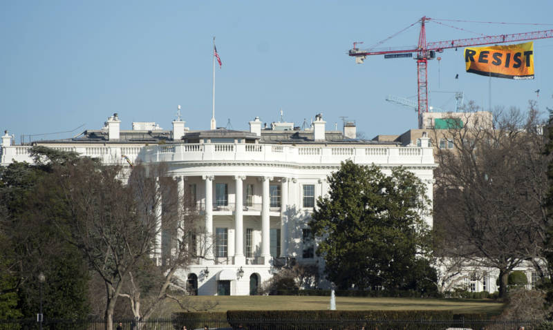 Greenpeace protesters hung a banner reading 'Resist' from atop a construction crane behind the White House on January 25, 2017.