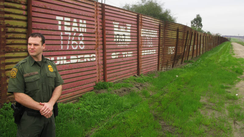 Border Patrol agent James Nielsen stands near the original landing-mat border fence near Chula Vista.