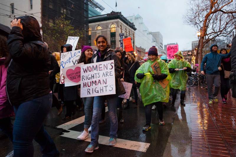Protestors wearing rain jackets and ponchos brave the rain as they march through San Francisco streets during the Women’s March on Jan. 21, 2017.