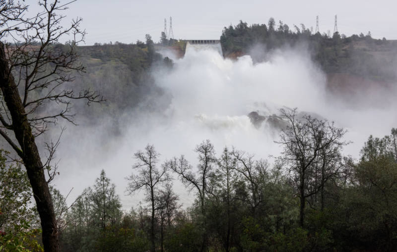 A huge spray cloud hangs over the Oroville Spillway as the California Department of Water Resources continues to release 100,000 cubic feet per second (cfs) from the damage spillway to decrease the lake level by 50 feet to handle the next round of storms expected this week. Photo taken February 13, 2017. 