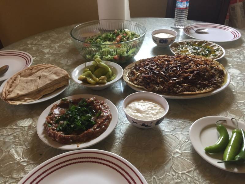 Rawaa Kasedah hopes to teach Syrian cooking classes and eventually open a Syrian restaurant that will feature dishes like mujaddara, shown here. It's a classic meal that consists of lentils, bulgur, and fried onions. Kasedah accompanies the dish with baba ganoush, salad, yogurt, and homemade pickles.