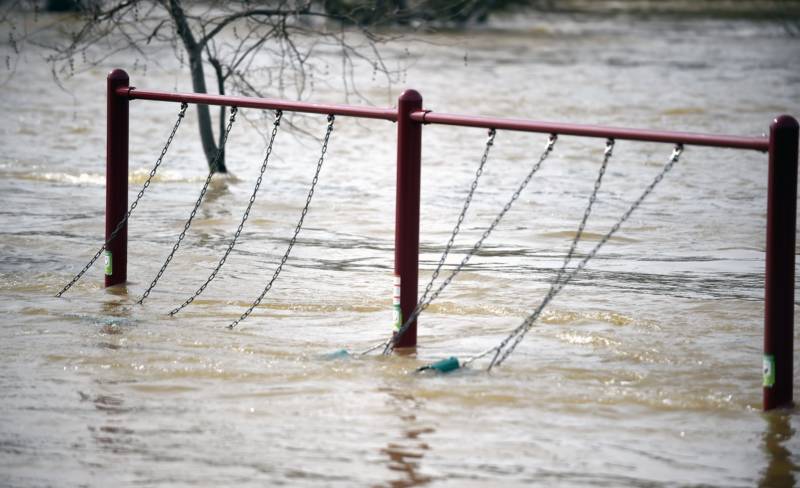 A swingset sways from rushing water at Riverbend Park as the Oroville Dam releases water down the spillway in Oroville, California, on Feb. 13, 2017. Almost 200,000 people were under evacuation orders in northern California Monday after a threat of catastrophic failure at the United States' tallest dam. Officials said the threat had subsided for the moment as water levels at the Oroville Dam, 75 miles (120 kilometers) north of Sacramento, have eased. But people were still being told to stay out of the area.