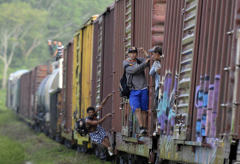 Migrants ride a train in Chiapas state, Mexico, on June 20, 2015. Hundreds of Central American migrants travel through Mexico on their way to the United States.