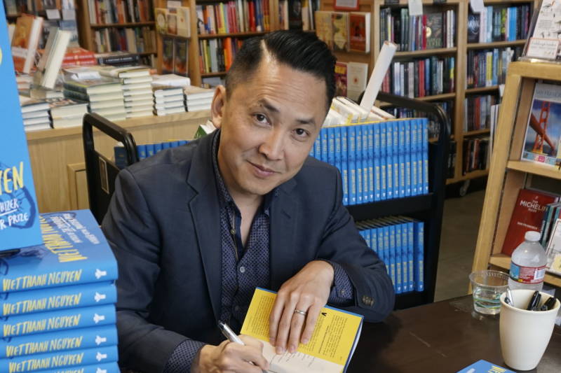 Pulitzer Prize-winning author Viet Thanh Nguyen signs copies of his new collection of short stories, "The Refugees." Nguyen came to the United States with his family as a refugee from Vietnam after the end of the Vietnam War in 1975.