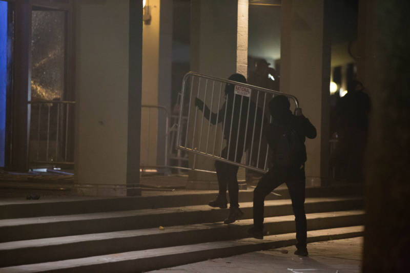 Militant protesters used police barricades to break windows on the Martin Luther King, Jr. Student Union building during a demonstration against the scheduled appearance of Milo Yiannopoulos at UC Berkeley on Feb. 1, 2017.