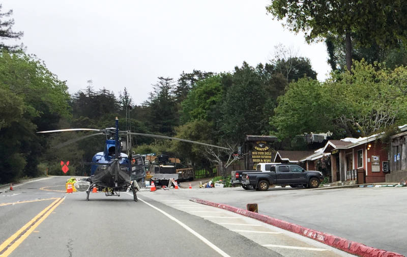 A helicopter sits on Highway 1. Since February, it's been one of the few ways in and out of the area south of the Pfeiffer Canyon Bridge.