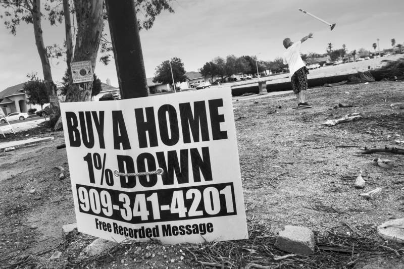 A sign lashed to street post across from Dream Street beckons would be home buyers with a seemingly irresistible offer.