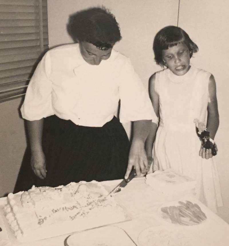 Nancy, after beginning treatment with Gary Fisher, cutting cake at a birthday party.