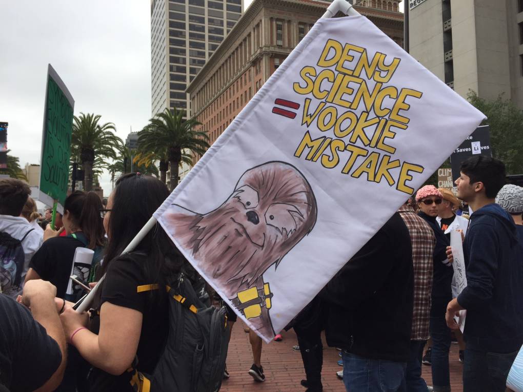 A woman holds a sign that says "Deny Science=Wookie Mistake" at the March for Science in San Francisco.