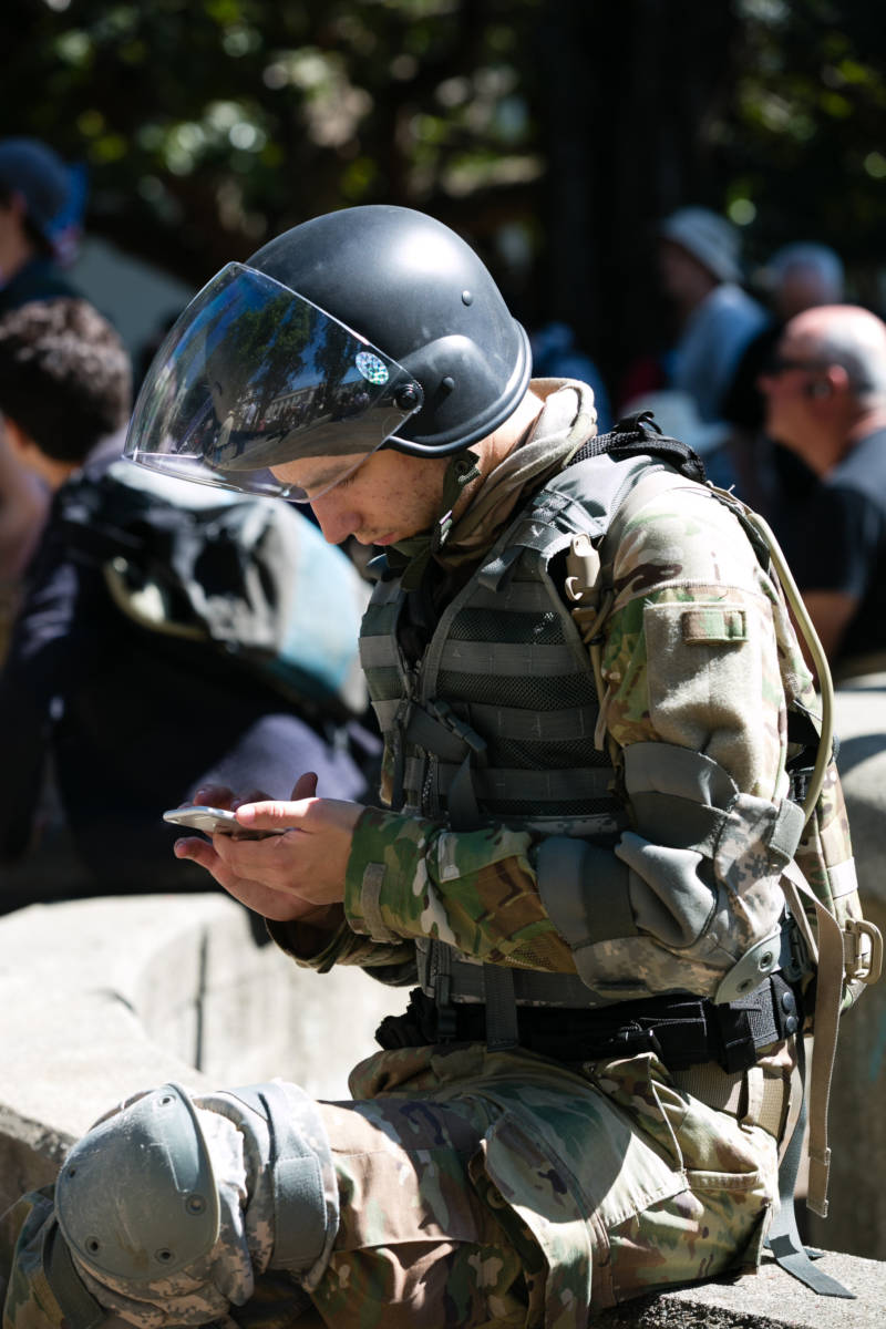 Owen Martinelli of San Rafael checked his phone during a conservative rally at Martin Luther King, Jr. Civic Center Park in Berkeley on April 27, 2017. Protesters originally planned to support an appearance by Ann Coulter at UC Berkeley, but when her event was canceled they held an event anyway.