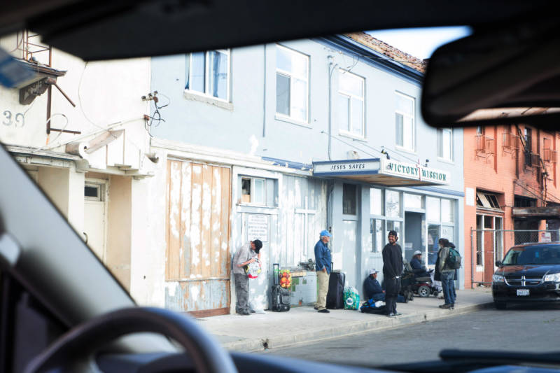 The view out of Commander Crabill's police vehicle shows homeless residents standing outside Victory Mission, a homeless services center in Salinas' Chinatown.