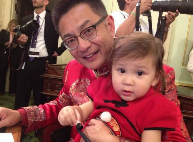 Asm. Kansen Chu with his granddaughter Kimberly at a swearing in ceremony.