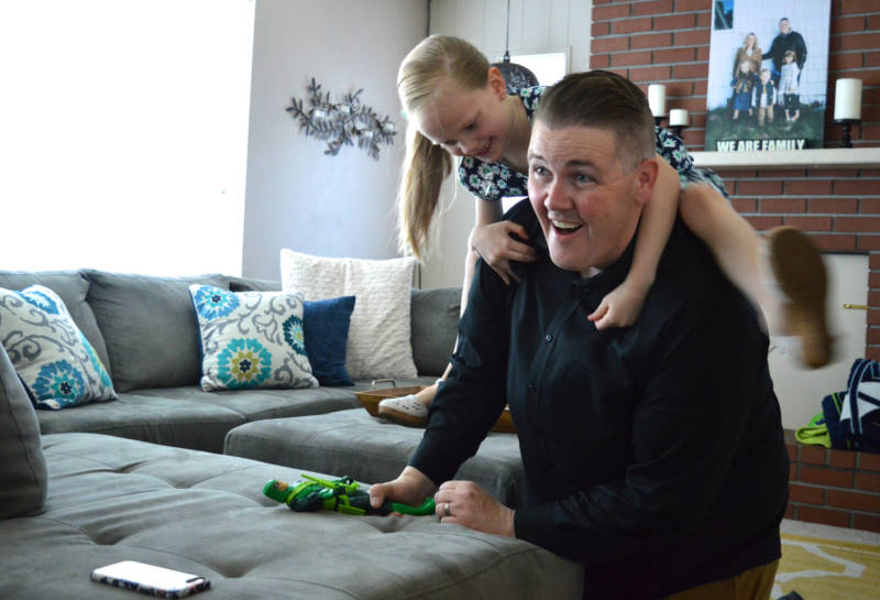 Nick Emery plays around with his oldest daughter Nevaeh, 8, at their Carson City home. She's one of three adopted children in the Emery household.