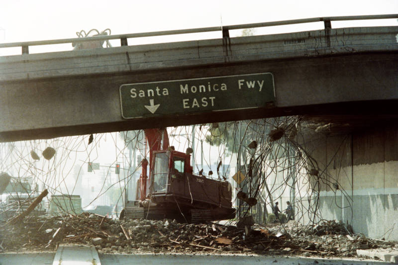 A bulldozer tears down a section of the Santa Monica Freeway that collapsed during the Northridge earthquake in 1994.