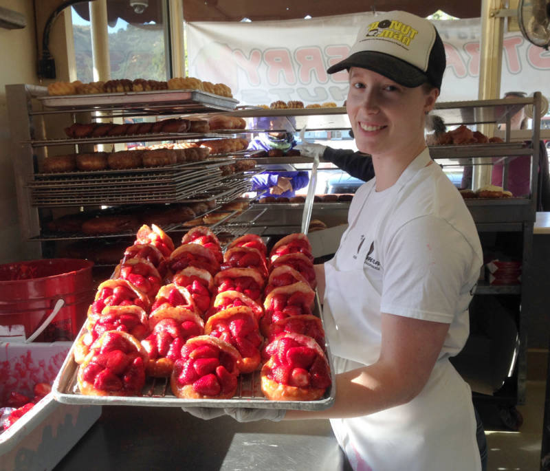 Katelyn Johnson displays The Donut Man's calling card: the strawberry donut.