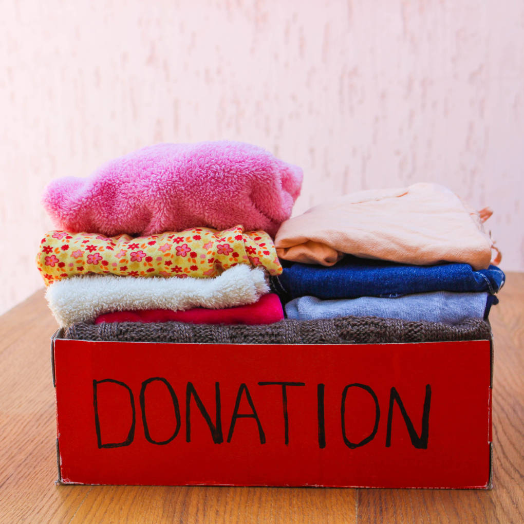 There a number of organizations that will take used clothing, and recycle anything not fit for reuse.