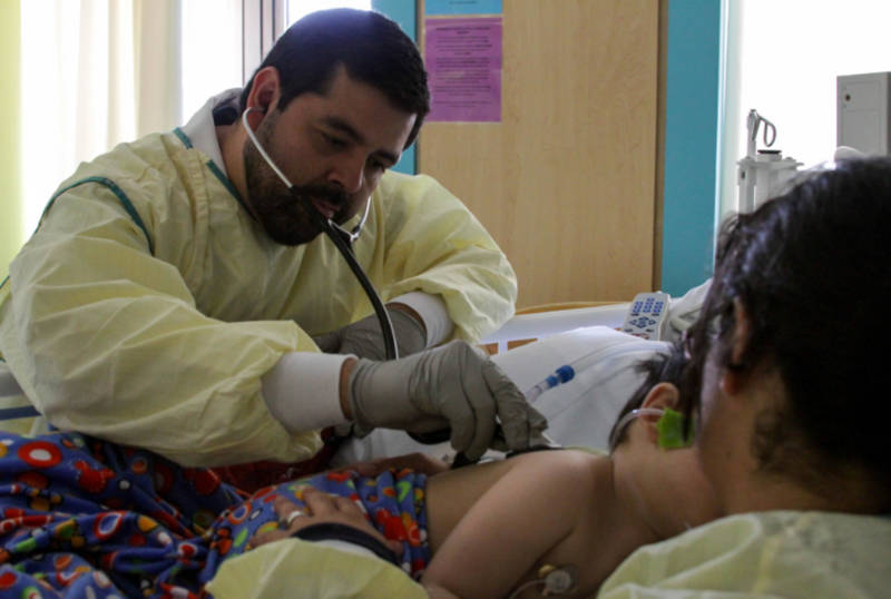 Dr. Rudy Silva checks on one of his patients in the Pediatric Intensive Care Unit at the Loma Linda University Medical Center.