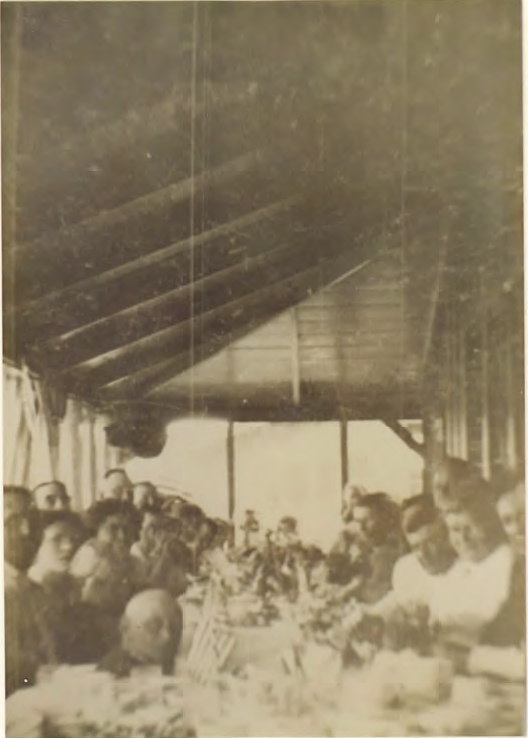 Dining inside the front porch at the Sprung Hotel. Mrs. Sprung second from right.