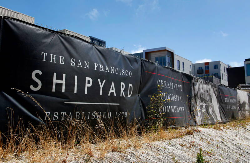 Signs advertising the new Shipyard development surround one of the project's ongoing construction sites at Hunters Point.