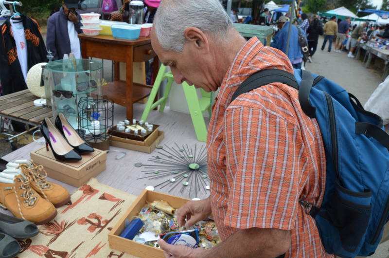 Alan Rosenzweig looks through a box of buttons at a flea market on Sunday, Aug. 6, 2017. Rosenzweig goes to at least one and often two flea markets every Sunday to add to his button collection.