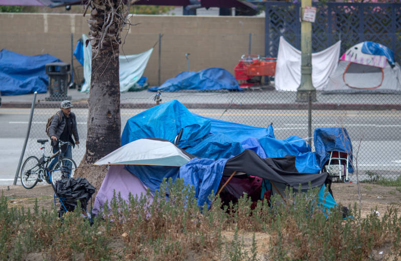 A homeless man returns to his encampment on May 1, 2017 in Los Angeles.