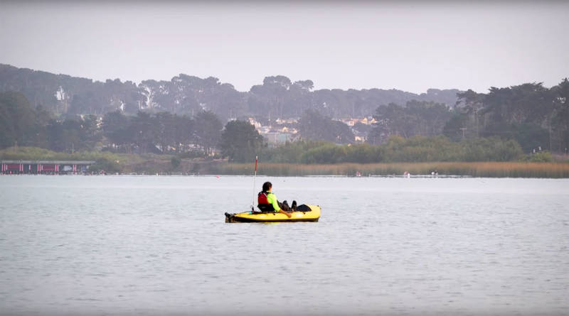 Ustunel paddles his kayak solo on San Francisco's Lake Merced.
