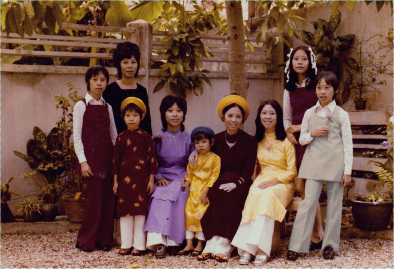 Jessica (far left) and Evelyn (far right) with their family before they left Vietnam.