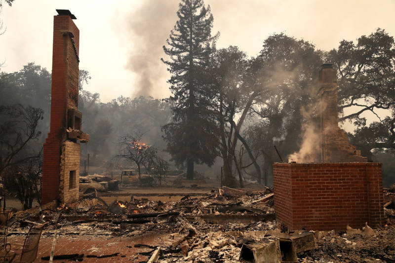 Remains of destroyed homes smolder in Glen Ellen on October 9, 2017. Tens of thousands of acres and dozens of homes and businesses have burned in a widespread wildfire that is burning in Napa and Sonoma counties.