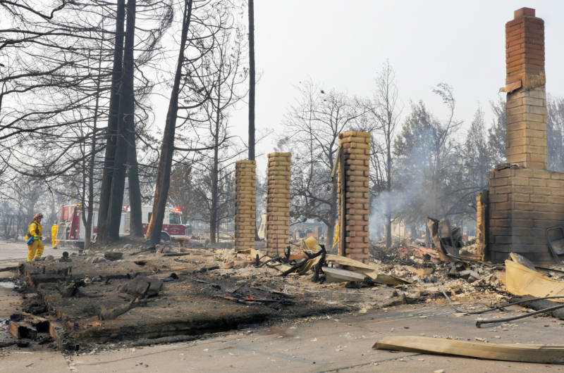 Firefighters work near burned homes and debris in Santa Rosa's Coffey Park subdivision.