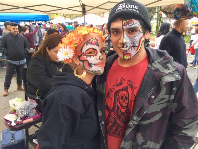 Jennifer Hale and Lorenzo Ortiz had their faces painted as Dia de los Muertos skulls. They were among the many young people at the festival. 