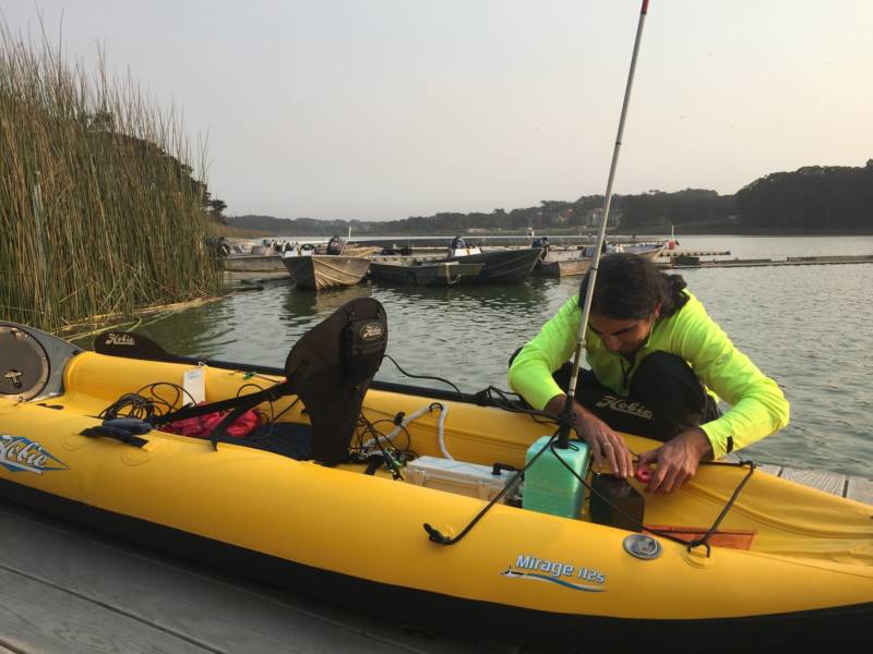 Ahmet Ustunel sets up his kayak with many gadgets to help him navigate the water. He attaches his white cane to his boat to indicate that he is blind.