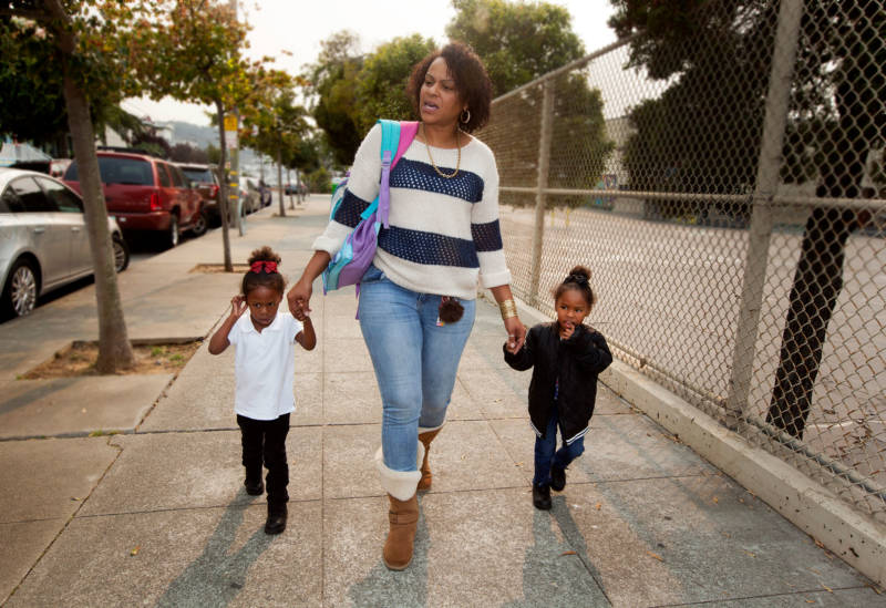 Raushanah Riles walks her twin nieces home from pre-school at Charles R. Drew College Preparatory Academy in the Bayview.