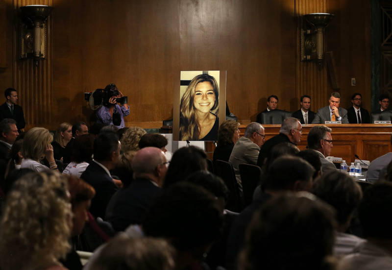 A large photo of Kathryn Steinle is shown while her dad, James Steinle, testifies during a Senate Judiciary Committee hearing on Capitol Hill, July 21, 2015, in Washington, D.C. The committee heard testimony from family members who have had loved ones killed by undocumented immigrants.
