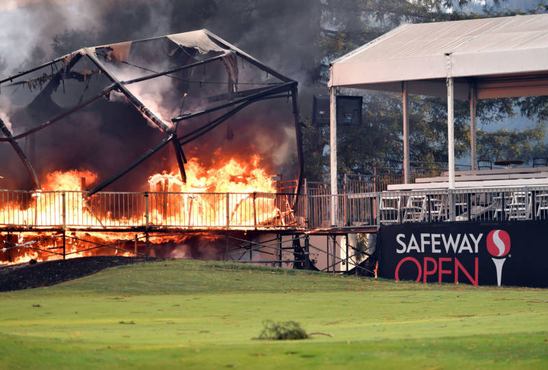 A tent structure built for the 2017 Safeway Open burns on a golf course at the Silverado Resort and Spa in Napa on October 9, 2017, as multiple wind-driven fires continue to whip through the region.