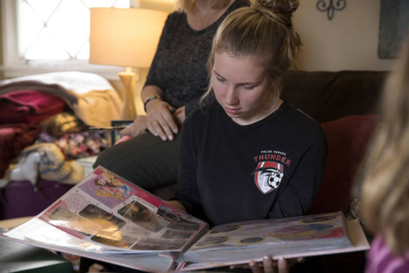 Amber Patterson looks at family photo albums at home in Lomita on Oct. 30, 2017.
