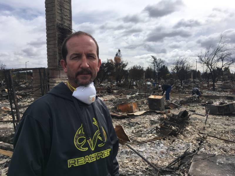 Brett Donnells in front of his burned homesite in Coffey Park the same day the insurance adjuster came to assess his losses. 