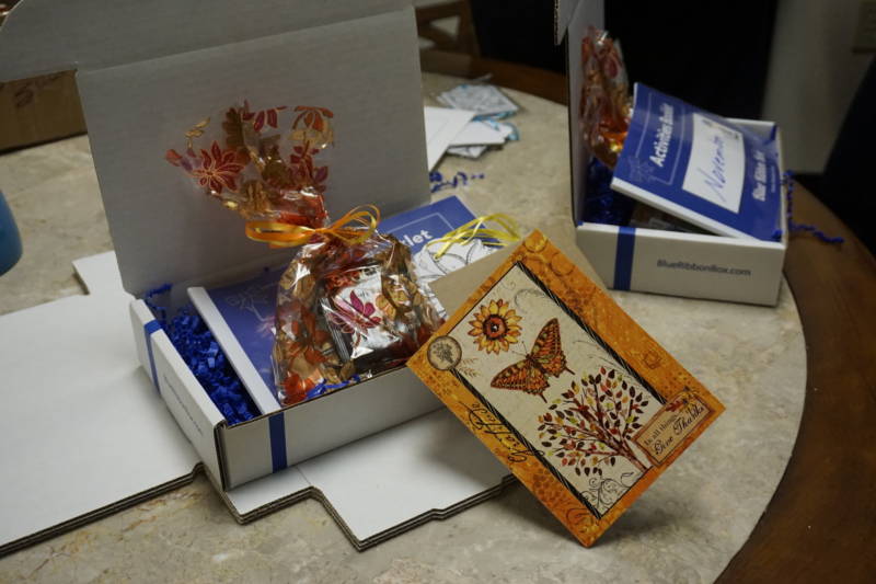 The Blue Ribbon Box is kind of like a weekly veggie box, but instead it includes a handwritten card, chocolates, tea, crossword puzzles and uplifting quotes.