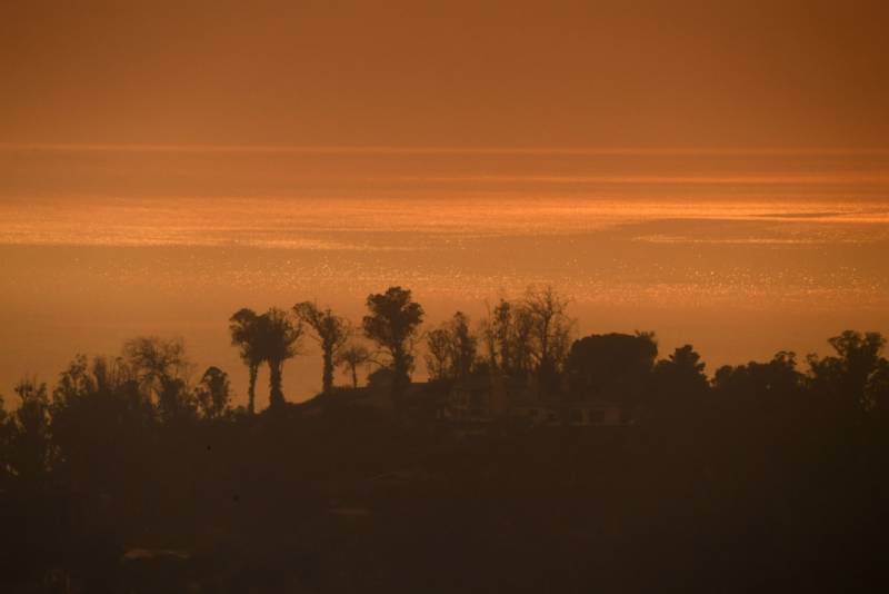 The mid-afternoon view of the Pacific Ocean from a hillside in Montecito, California is orange due to smoke from the Thomas Fire on December 16, 2017.