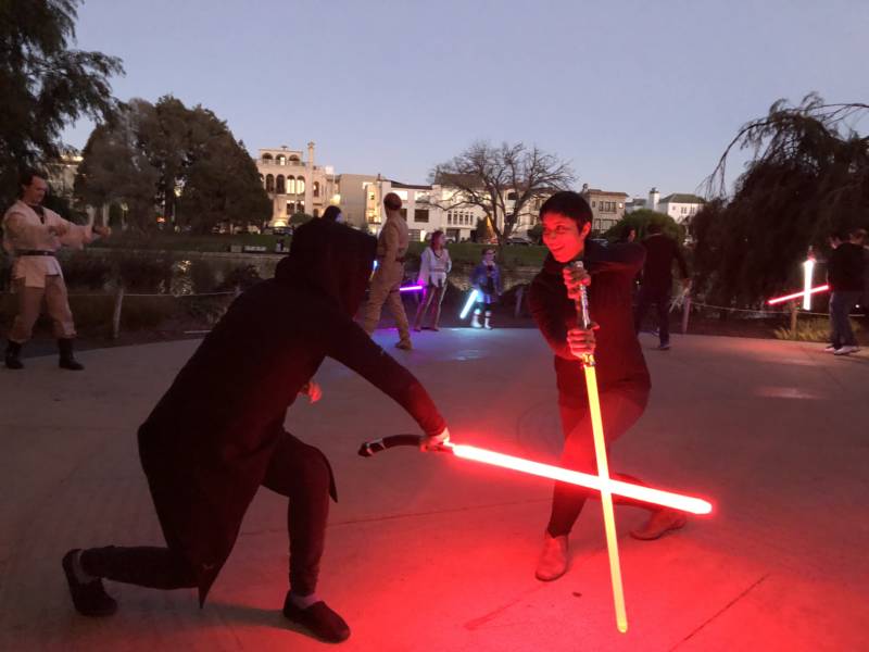 Jin di Giordano, Vallejo and Shawna Seth, San Francisco, practice a new technique at a Saber Guild event. Local lightsaber combat groups practice across the Bay Area and give Star Wars fans a unique workout experience.