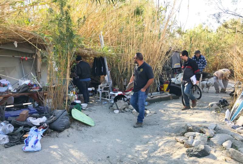 Homeless outreach workers visit a homeless camp in the Tujunga-Sunland area near Sylmar.