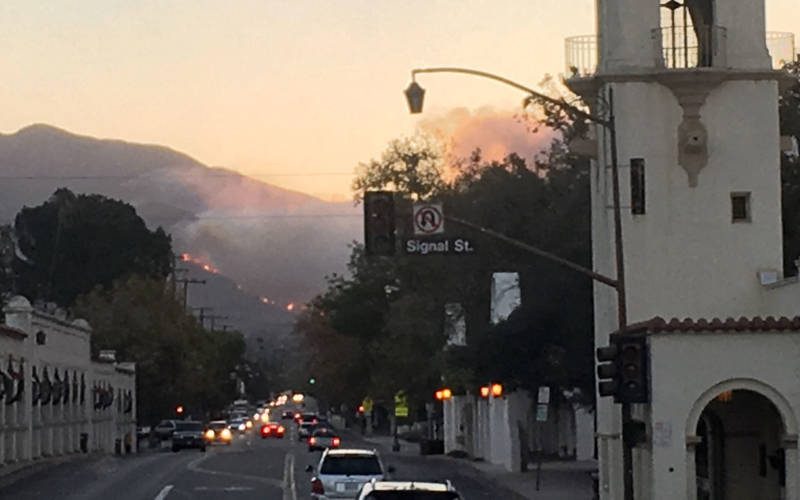 The Thomas Fire burns on a hillside as seen from downtown Ojai.