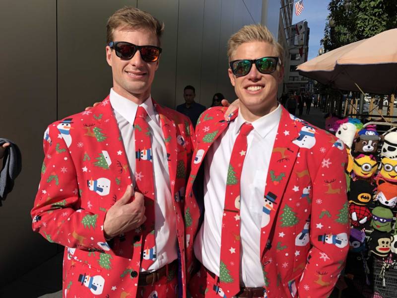 Dan Beckmann and Chris Lynch wear their special Christmas suits for SantaCon 2017 at San Francisco's Union Square.