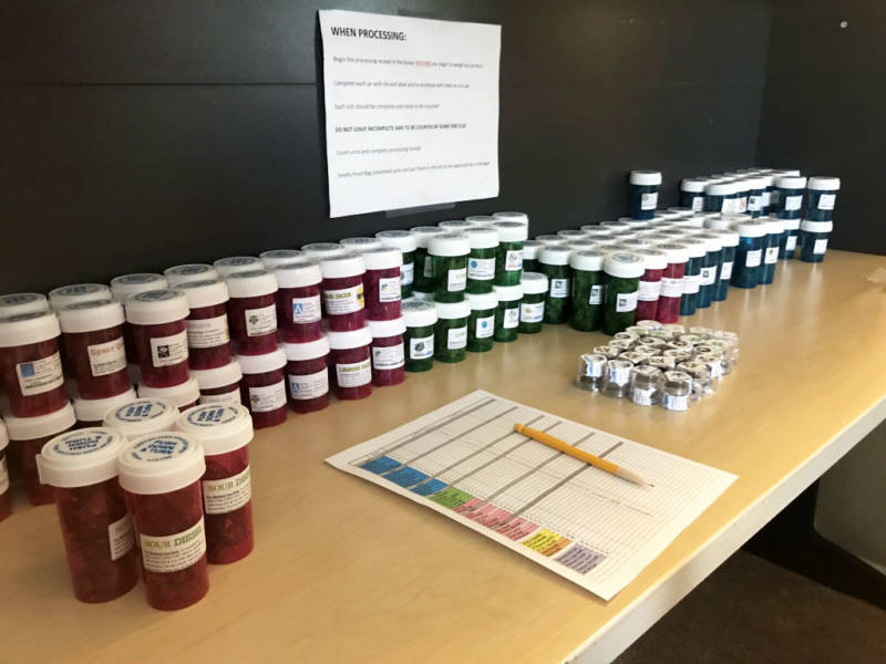 Vials of medical marijuana line a desk at the headquarters of a delivery service in south Orange County on Nov. 29, 2017.