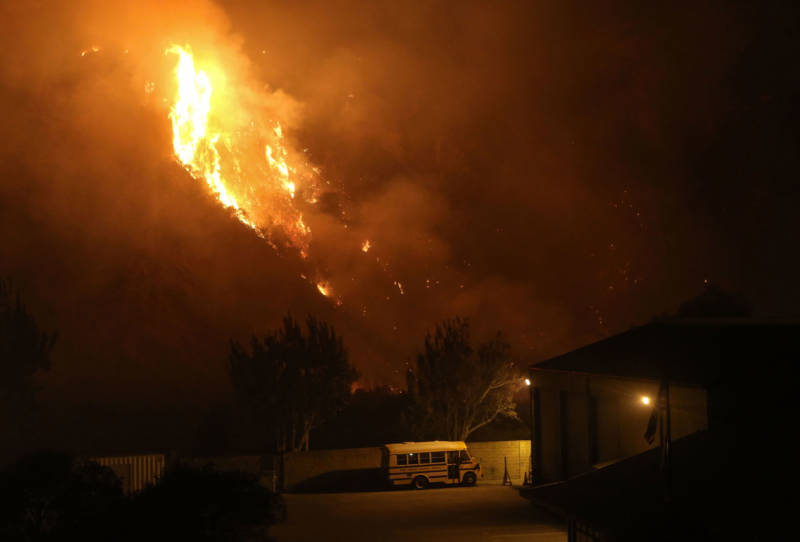 The Thomas Fire burns near a school bus on Dec. 7, 2017 in Ventura.