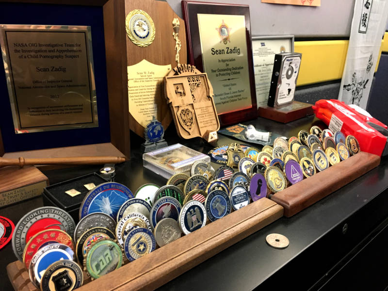 As a former federal agent, Zadig has a collection of these so-called challenge coins, which are exchanged by law enforcement agents during visits.