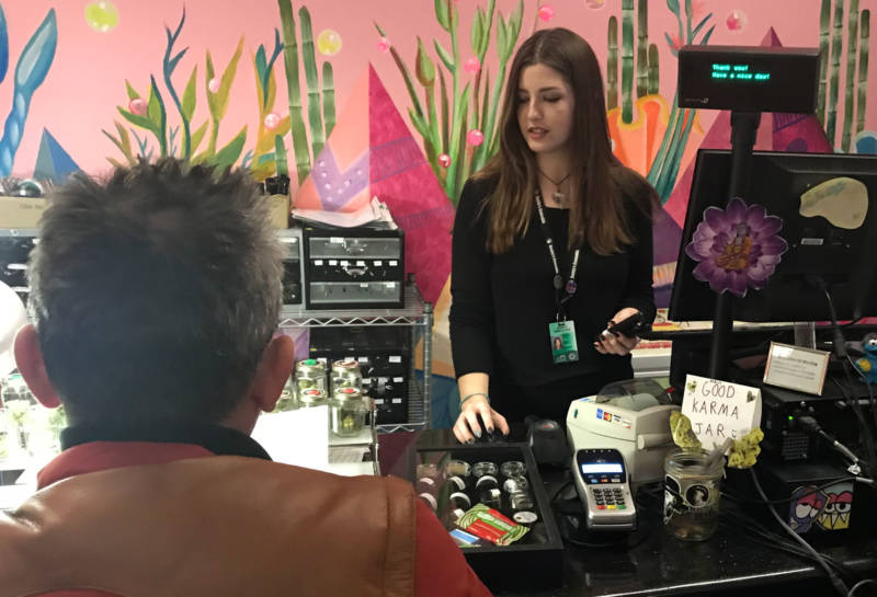 An employee helps a customer at Buddy's Cannabis in San Jose.